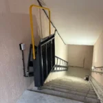 Похилий підйомник для інвалідних візків у складеному положенні на сходовому марші